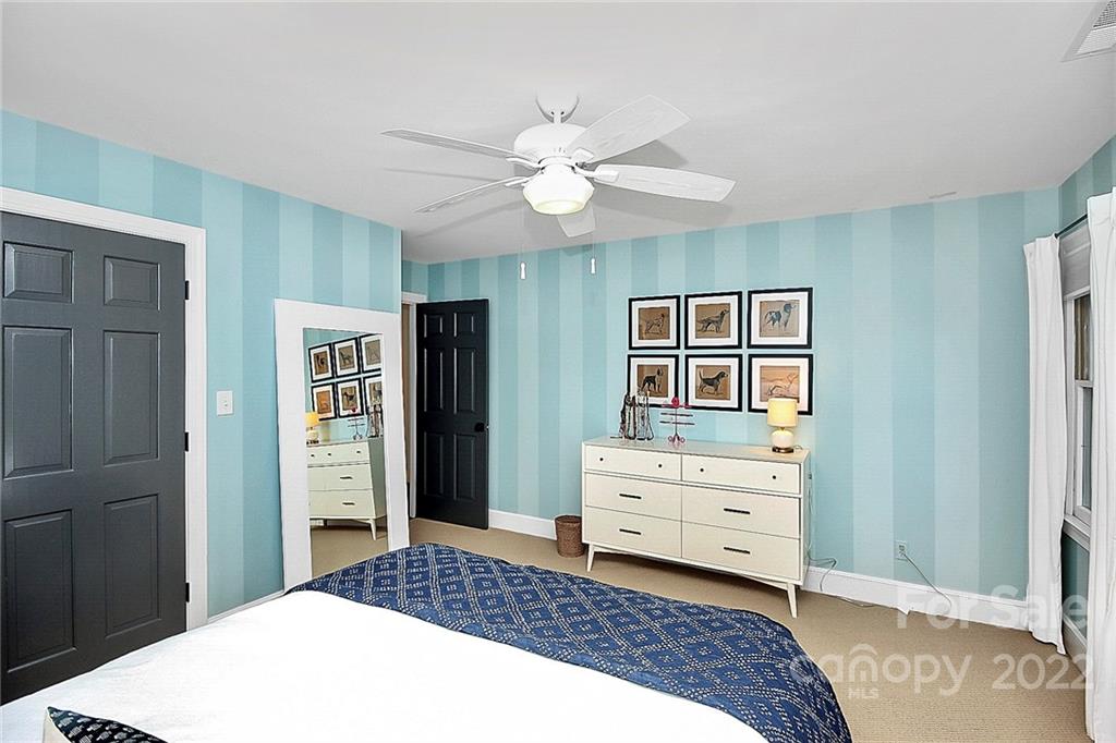 7319 St Clair Drive Charlotte, NC 28270 - Photo 18 of 39 a bedroom with a bed and a chandelier