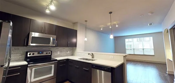 a kitchen with a sink stove top oven and microwave