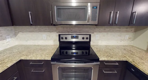 a stove top oven sitting inside of a kitchen