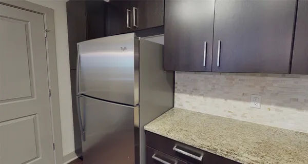 a kitchen with metallic refrigerator freezer and a dishwasher