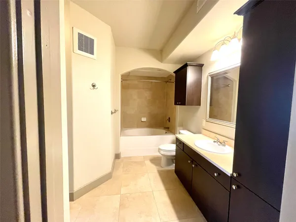 a bathroom with a bathtub and a toilet