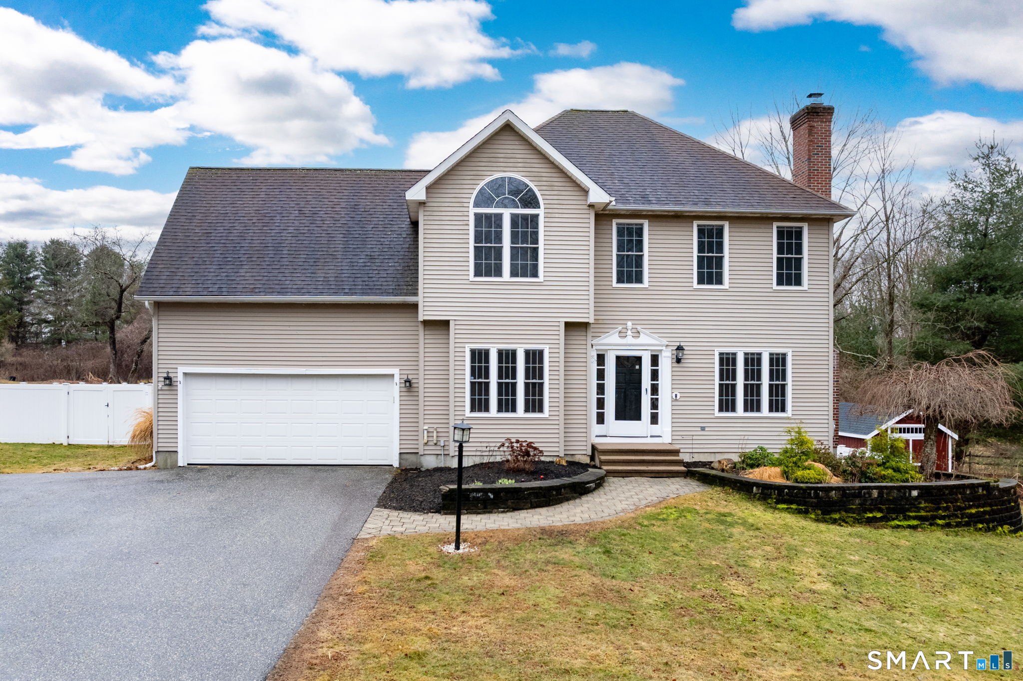 559 West Main Street Hebron, CT 06231 - Photo 1 of 29 a front view of a house with a yard table and chairs