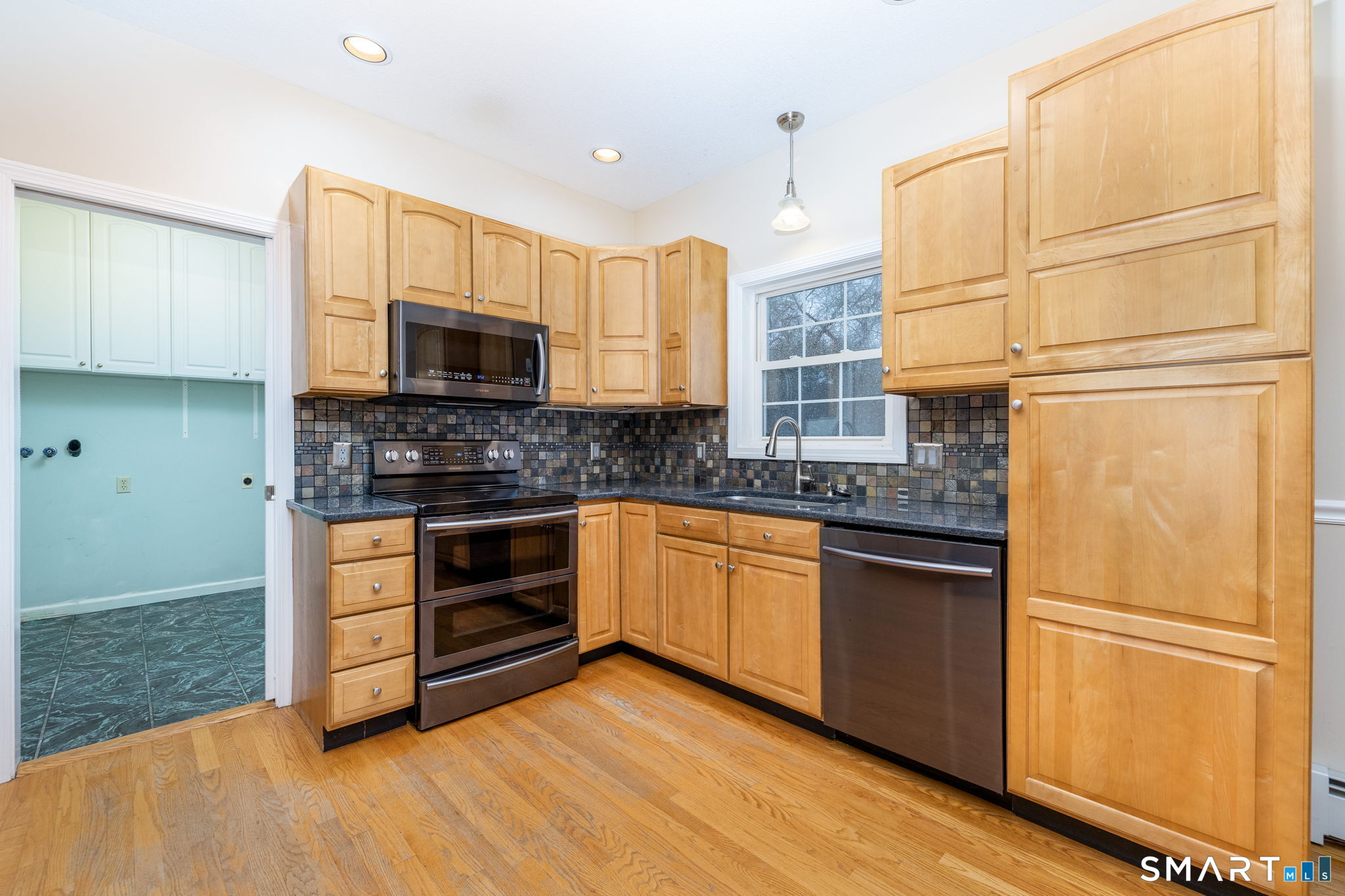 559 West Main Street Hebron, CT 06231 - Photo 3 of 29 a kitchen with stainless steel appliances granite countertop a stove a sink and a refrigerator