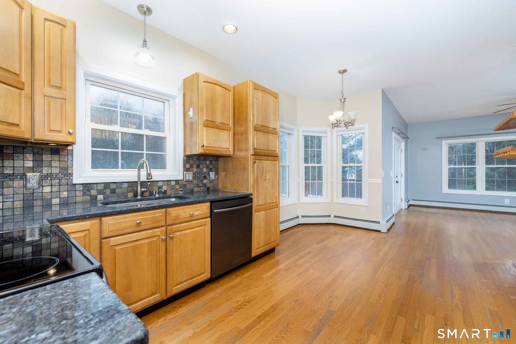 559 West Main Street Hebron, CT 06231 - Photo 4 of 29 a view of a kitchen with granite countertop a sink and cabinets