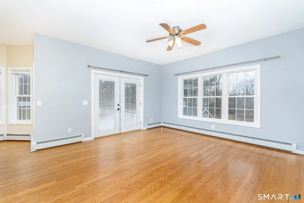 a view of a livingroom with a ceiling fan and window
