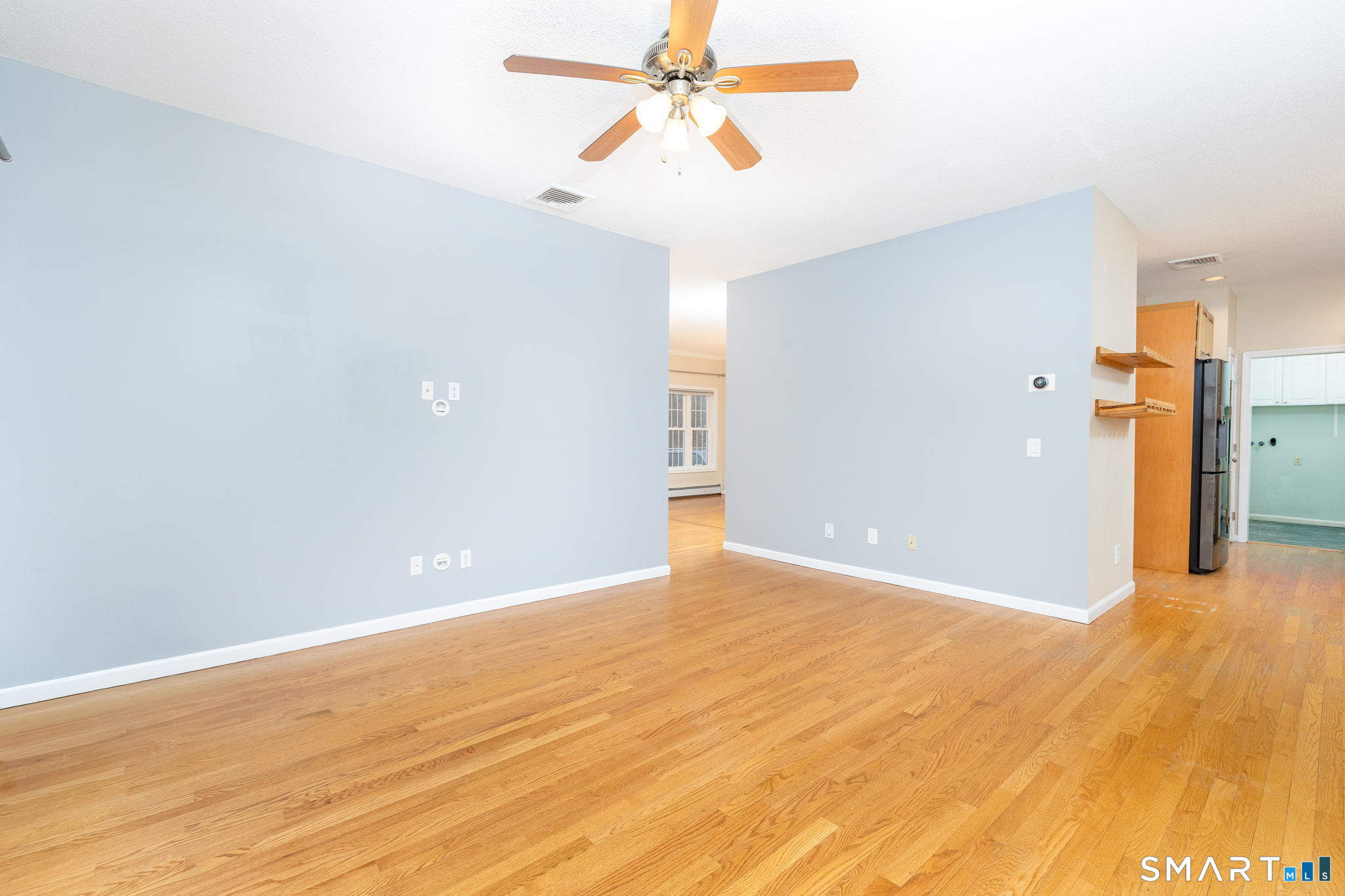 559 West Main Street Hebron, CT 06231 - Photo 8 of 29 a view of a big room with wooden floor and a ceiling fan