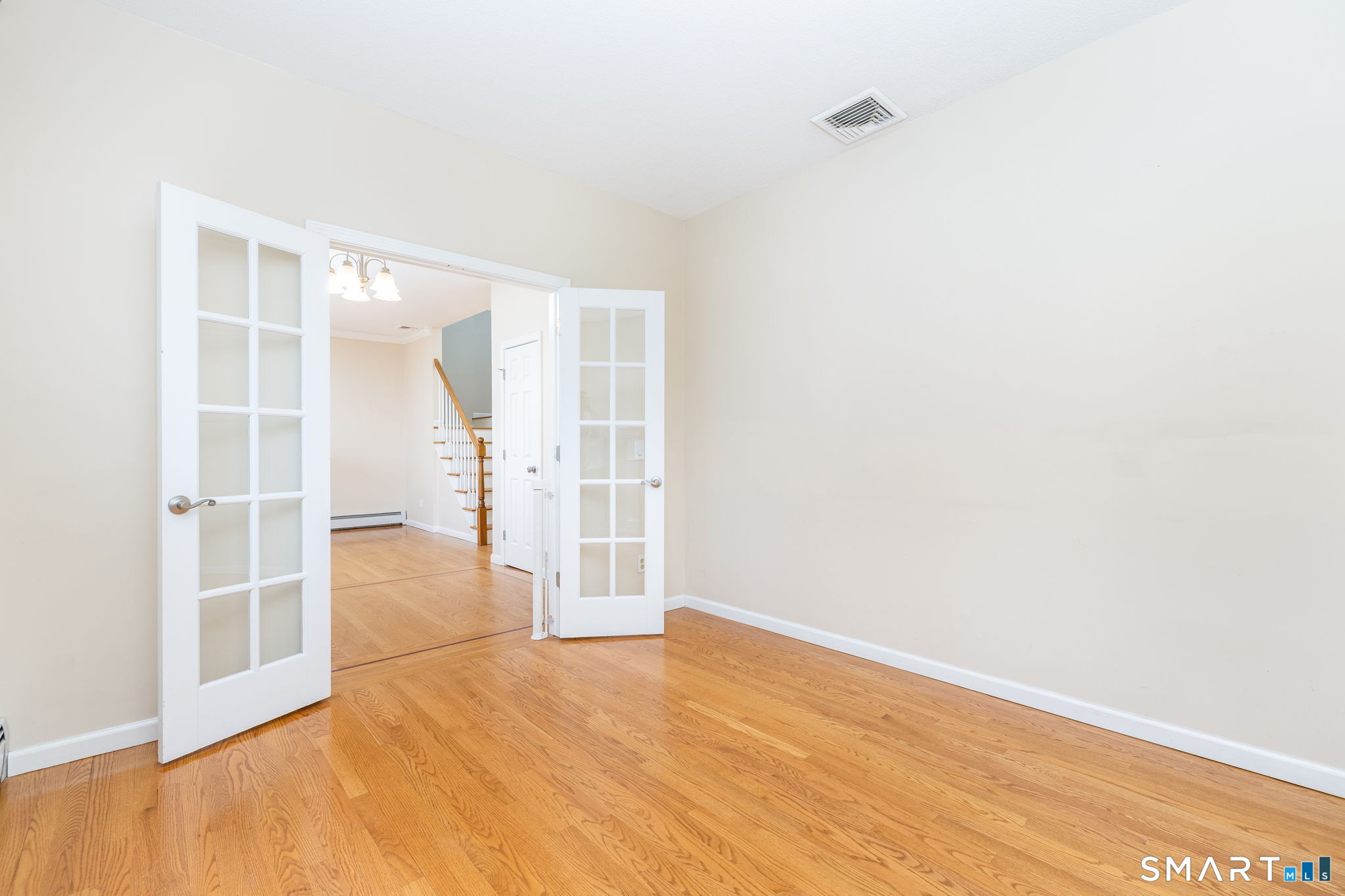 559 West Main Street Hebron, CT 06231 - Photo 9 of 29 an empty room with wooden floor and windows