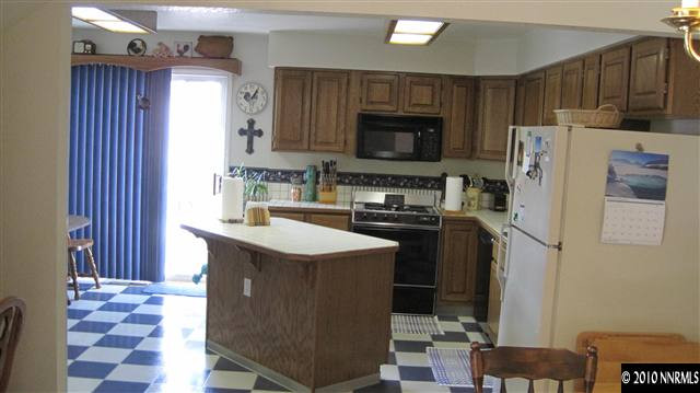 3661 Shale Court Reno, NV 89503 - Photo 3 of 9 a kitchen with a sink a stove a refrigerator and a microwave