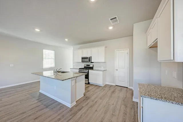a view of kitchen with granite countertop cabinets and steel stainless steel appliances
