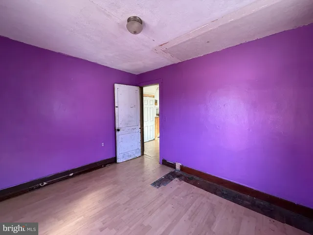 a view of a room with wooden floor and a window