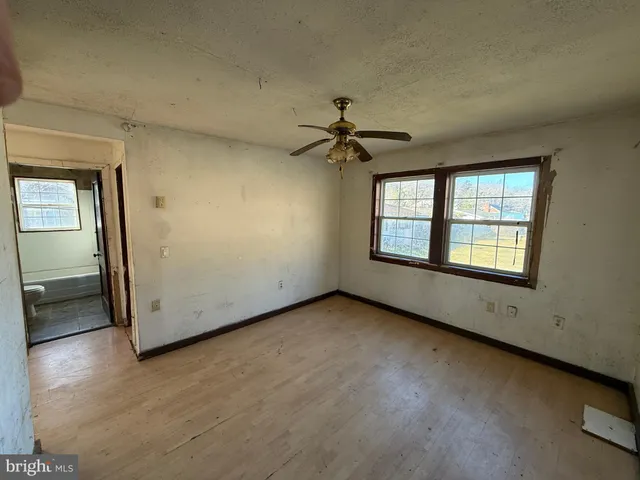 an empty room with a empty space and windows