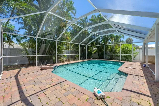 a view of a backyard with table and chairs wooden floor and fence
