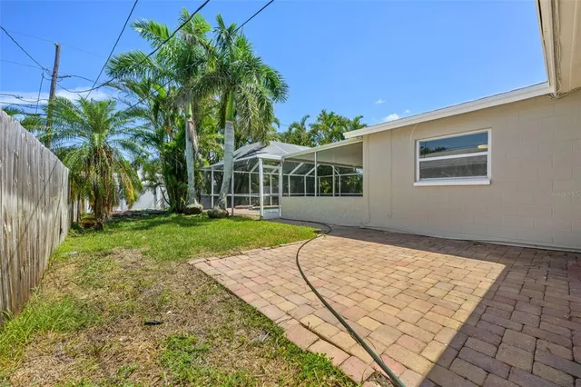a view of backyard with a garden and palm trees