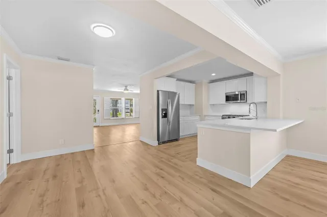 a view of kitchen with sink microwave and refrigerator