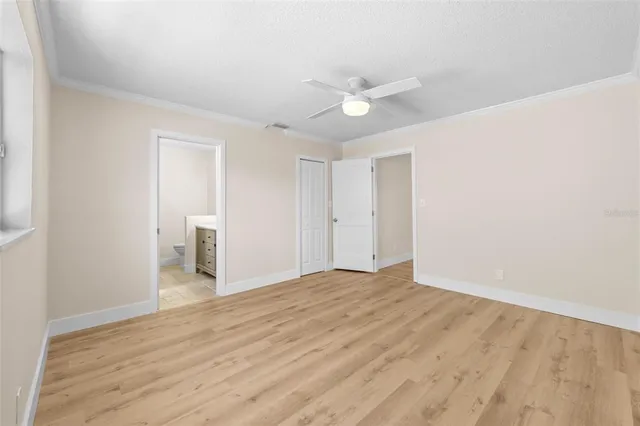 a view of an empty room with wooden floor