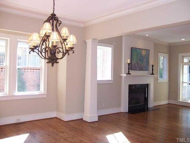 3410 Hatteras Court Raleigh, NC 27607 - Photo 5 of 12 a view of a livingroom with a fireplace wooden floor and windows