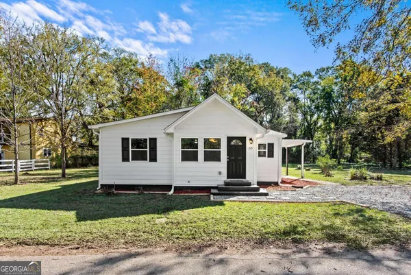 a front view of a house with garden
