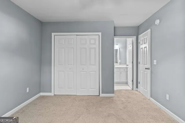 a bathroom with a toilet a sink a vanity and mirror