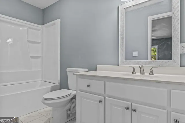 a view of a bathroom from a hallway