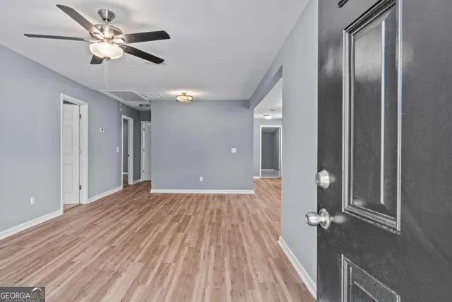 a view of empty room with wooden floor