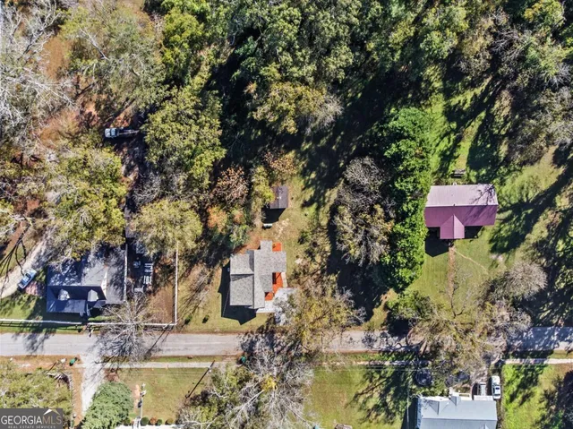 an aerial view of residential house and car parked