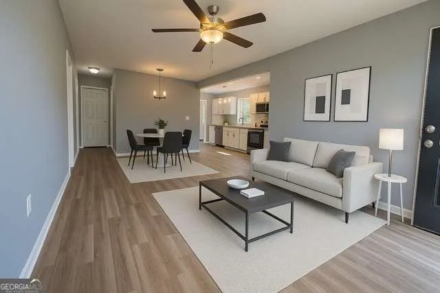 a living room with furniture and a wooden floor