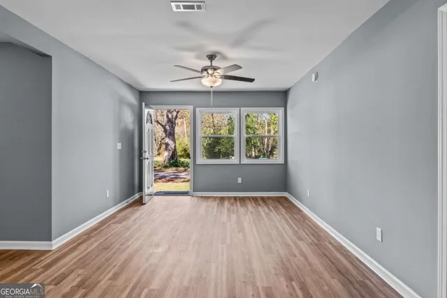 wooden floor in an empty room with a window