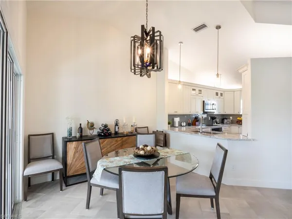 a kitchen with a table and chairs in it