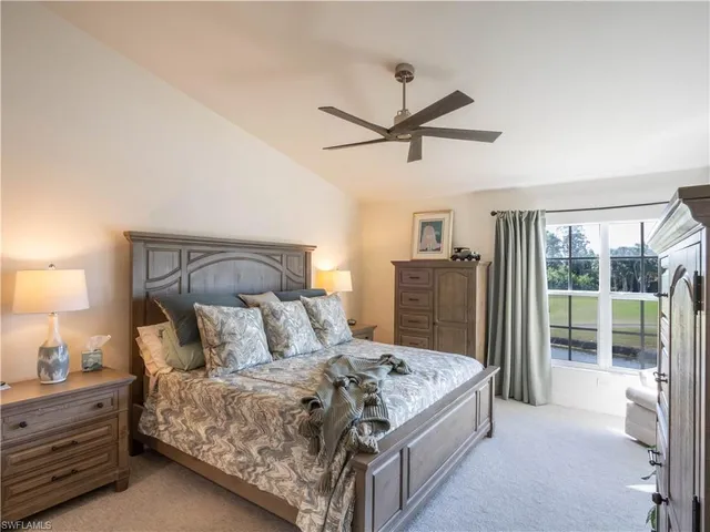 a bedroom with a bed and large mirror