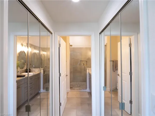 a bathroom with a glass shower door and a mirror