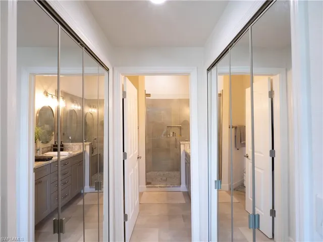 a bathroom with a glass shower door and a mirror