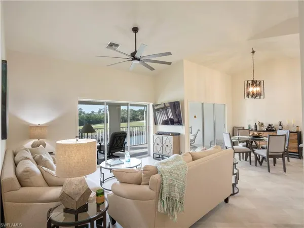 a living room with furniture a dining table and a fireplace