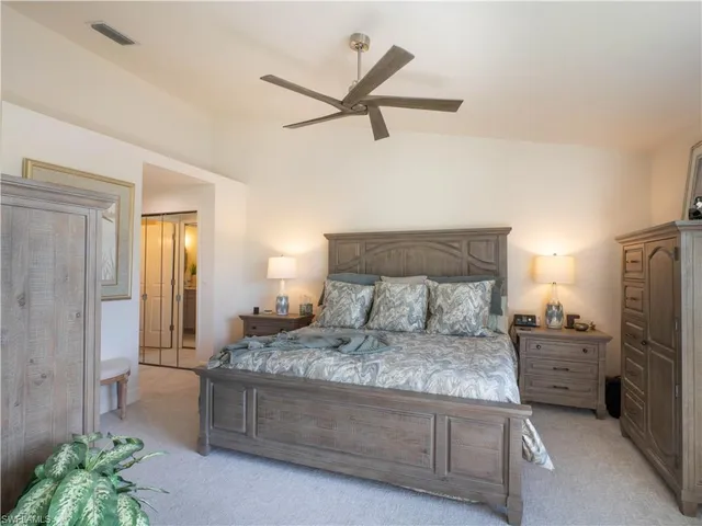 a bedroom with a bed and ceiling fan
