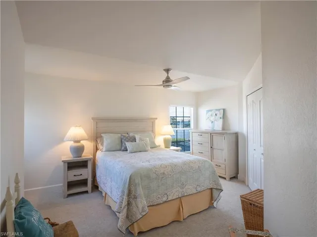 a bedroom with a bed and a lamp