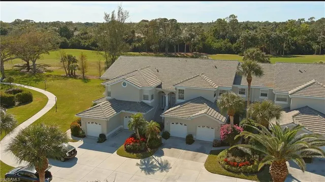 a aerial view of a house with a swimming pool and a yard