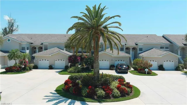 a view of a house with a yard and potted plants