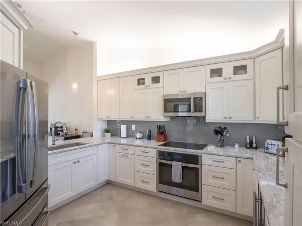 a kitchen with stainless steel appliances a sink stove and refrigerator