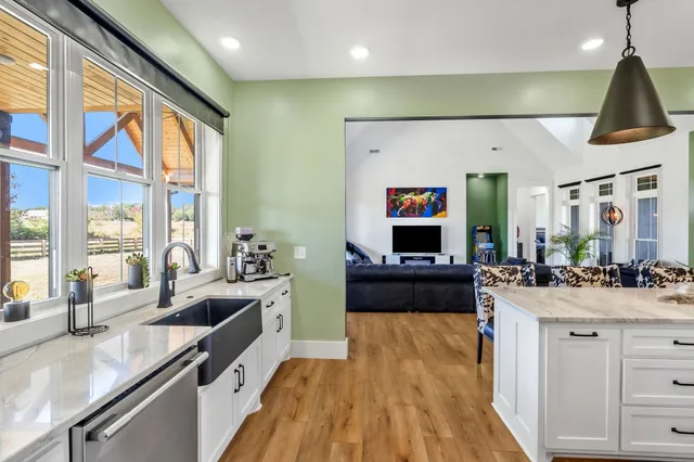 a living room with furniture dining table and a large window