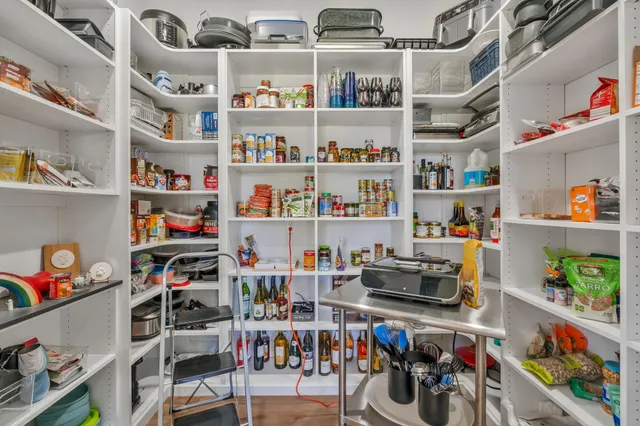 a living room with a bed furniture and a flat screen tv