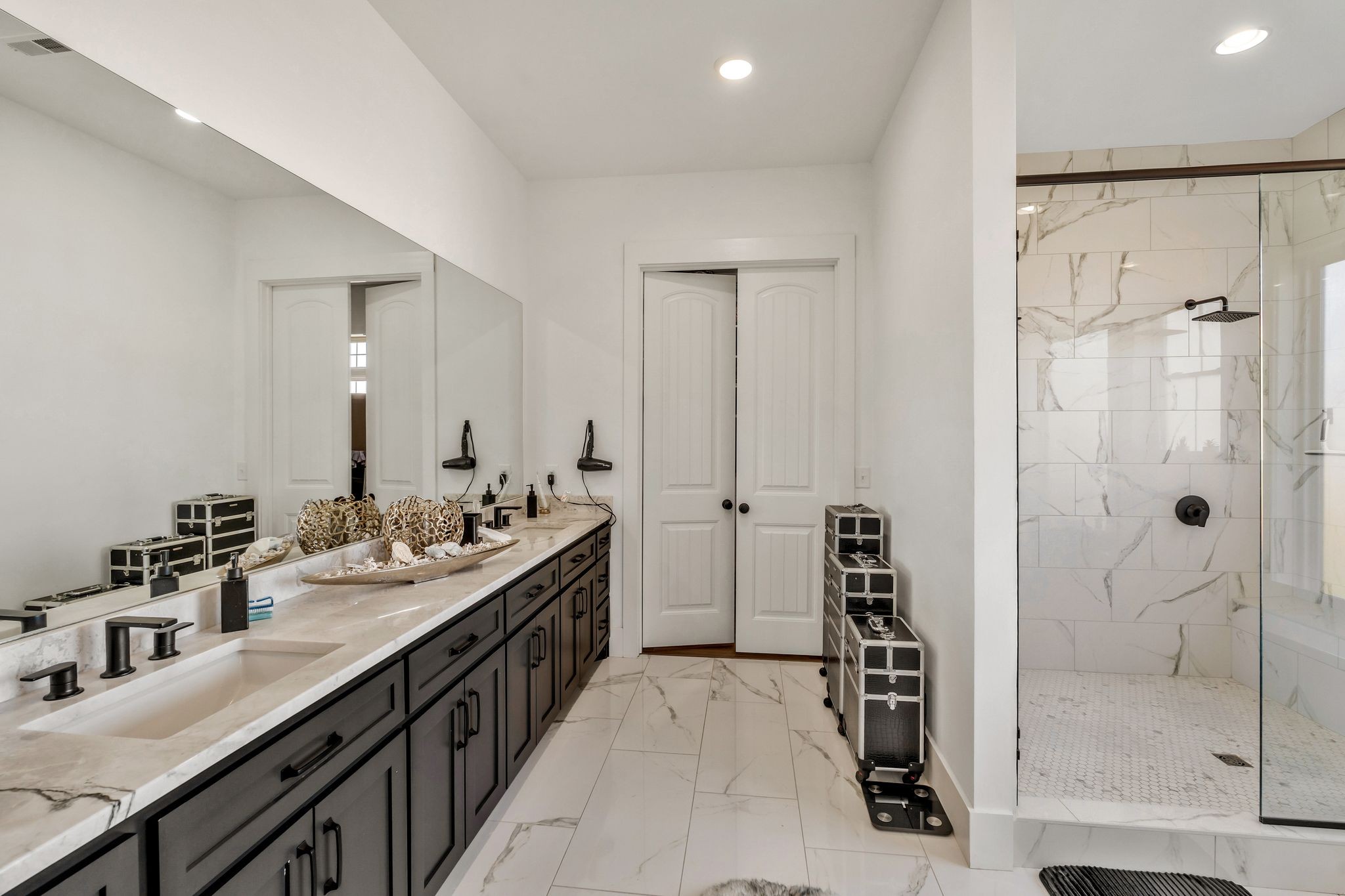 128 Emma Street Hohenwald, TN 38462 - Photo 31 of 96 a bathroom with a double vanity sink a large mirror and shower