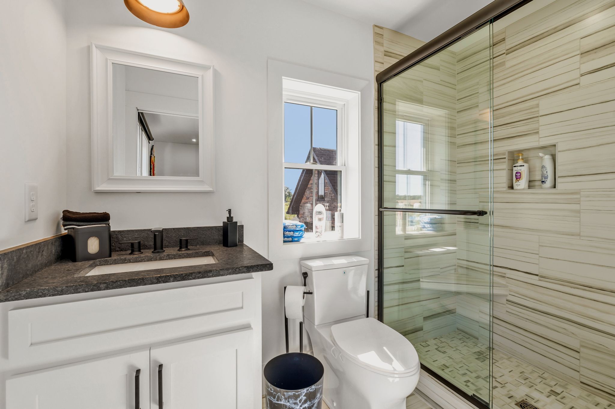 128 Emma Street Hohenwald, TN 38462 - Photo 42 of 96 a bathroom with a granite countertop sink a toilet and mirror