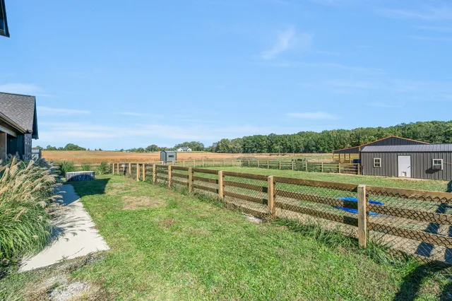 a large kitchen with stainless steel appliances a large counter top a stove a chimney a sink and dishwasher