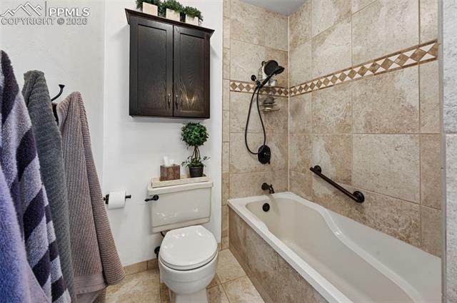 1012 North Chelton Road Colorado Springs, CO 80909 - Photo 39 of 46 Full bath with tiled shower / bath combo and light tile patterned flooring