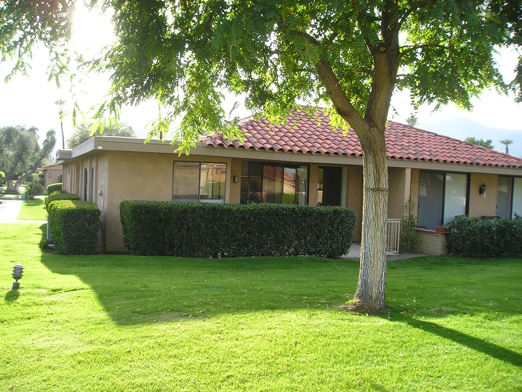 38 Malaga Drive Rancho Mirage, CA 92270 - Photo 36 of 37 a front view of a house with garden and trees
