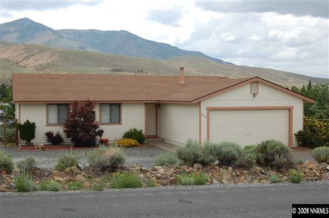 a view of a house with a yard and sitting area