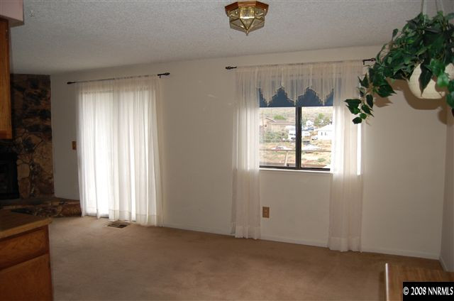 2265 Dakota Way Reno, NV 89506 - Photo 5 of 9 an empty room with windows and potted plants