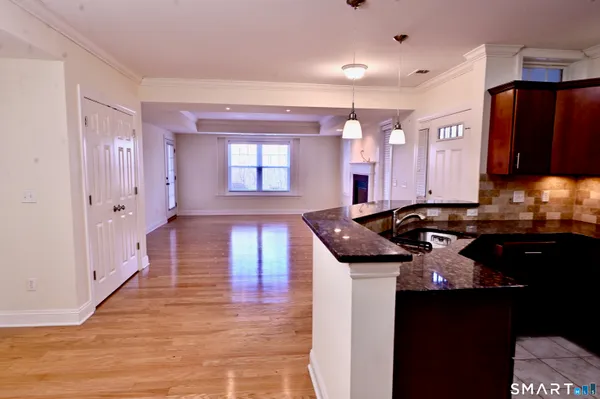 a kitchen with granite countertop a stove and a sink