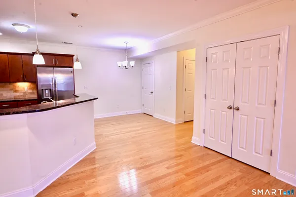 a view of a kitchen with a sink and a refrigerator