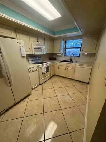 a kitchen with a sink a stove and cabinets