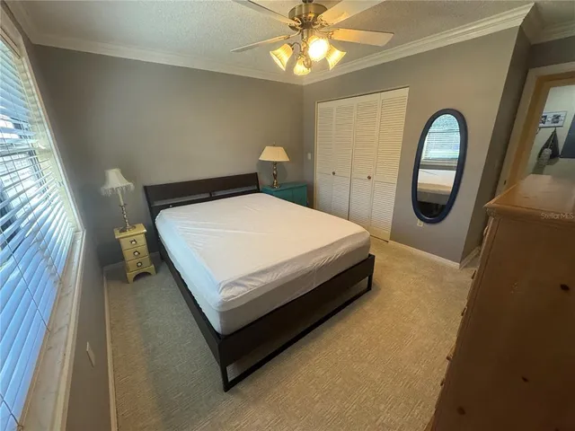 a bed sitting in a bedroom next to a window